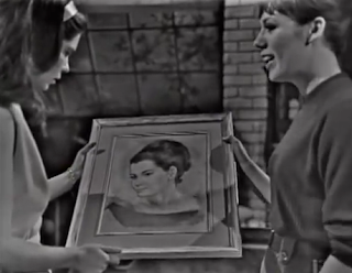 Vicki and Maggie hold the portrait of Betty Hanscombe